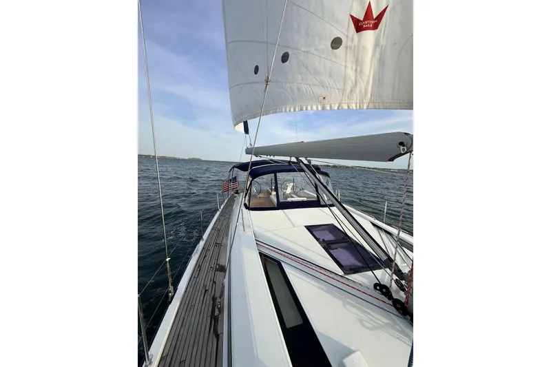 Slide: The Image of 2019 Beneteau Oceanis 51.1 sailing on open water, showcasing sleek design and sails. - 2