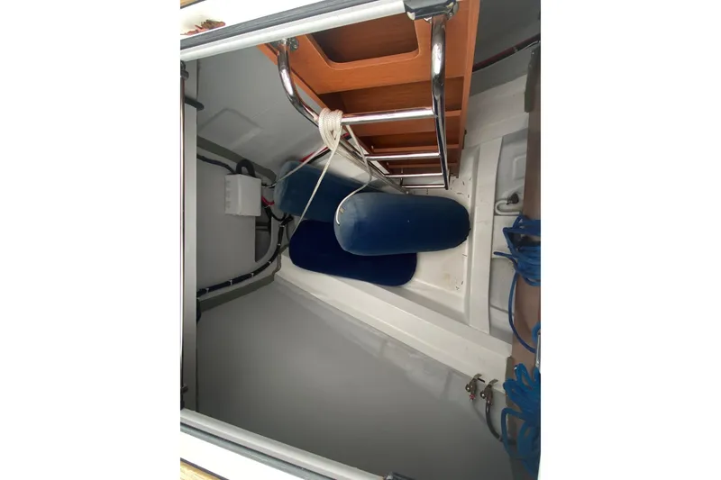 Slide: The Image of Interior view of 2019 Beneteau Oceanis 51.1 sailboat storage compartment with ladder and cushions. - 22