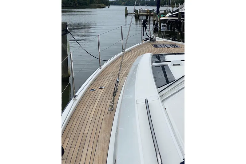Slide: The Image of 2019 Beneteau Oceanis 51.1 yacht docked, showcasing sleek wooden deck design. - 25