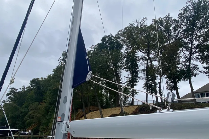 Slide: The Image of Mast and rigging of 2019 Beneteau Oceanis 51.1 sailboat against a wooded backdrop. - 26