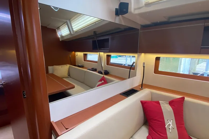 Slide: The Image of Interior of 2019 Beneteau Oceanis 51.1 yacht with cozy seating and elegant wood finish. - 27