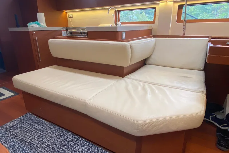 Slide: The Image of Luxurious interior seating on 2019 Beneteau Oceanis 51.1 yacht, featuring cream leather upholstery. - 28