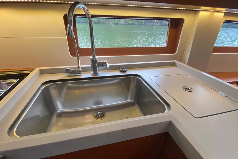 Slide: The Image of Modern kitchen sink in 2019 Beneteau Oceanis 51.1 yacht interior, with scenic window view. - 32