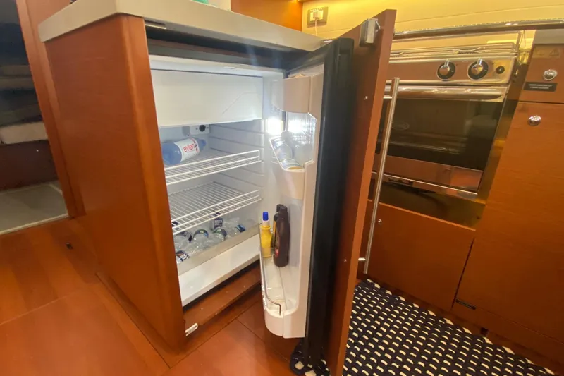 Slide: The Image of Open fridge in 2019 Beneteau Oceanis 51.1 yacht kitchen, stocked with beverages. - 35