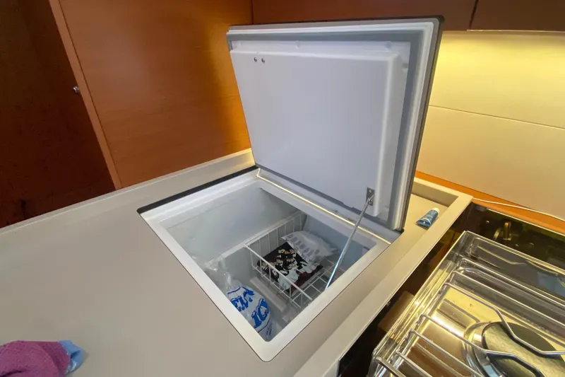 Slide: The Image of Open freezer in 2019 Beneteau Oceanis 51.1 yacht kitchen, showcasing interior storage space. - 36