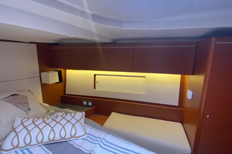 Slide: The Image of Interior cabin of 2019 Beneteau Oceanis 51.1 yacht, featuring modern design and cozy bedding. - 37