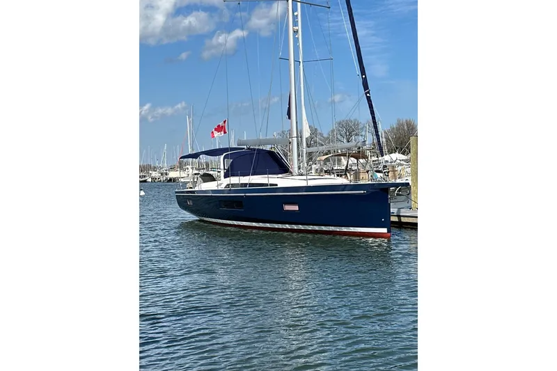 Slide: The Image of 2019 Beneteau Oceanis 51.1 sailboat docked in a marina with a Canadian flag. - 48