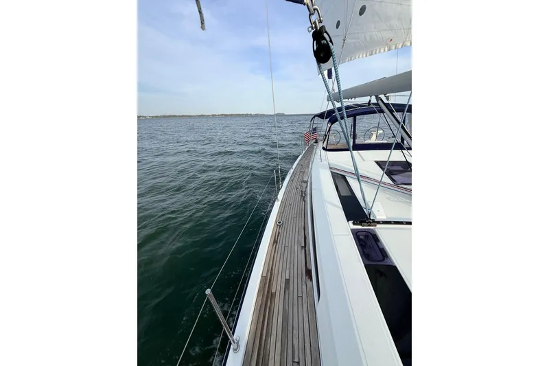 Slide: The Image of 2019 Beneteau Oceanis 51.1 sailing on open water, showcasing sleek deck design. - 6