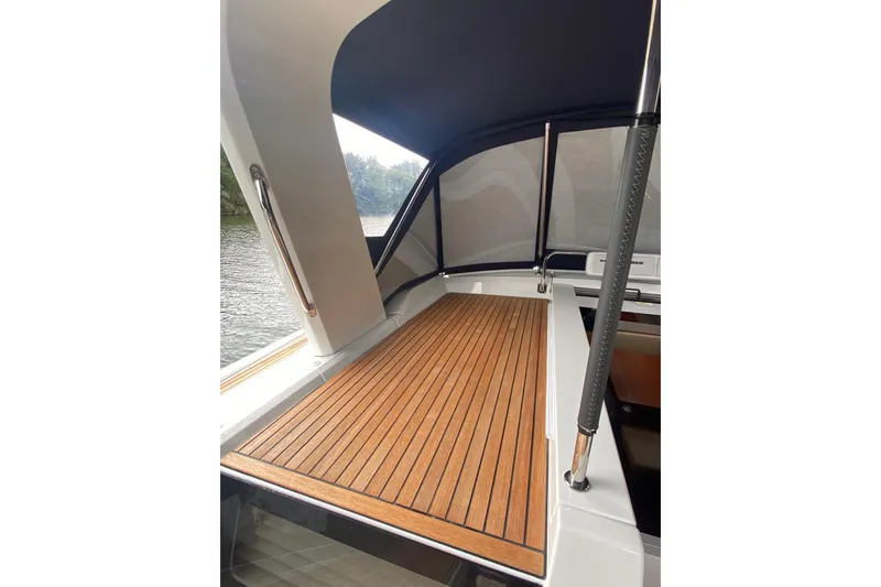 Slide: The Image of 2019 Beneteau Oceanis 51.1 yacht deck with teak flooring and canopy. - 9