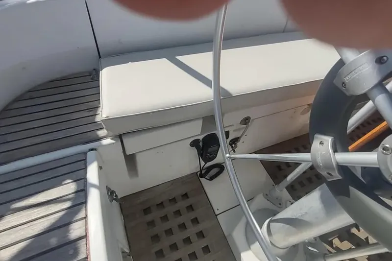 Slide: The Image of Cockpit of 1990 Beneteau Oceanis 390 sailboat with steering wheel and seating. - 10