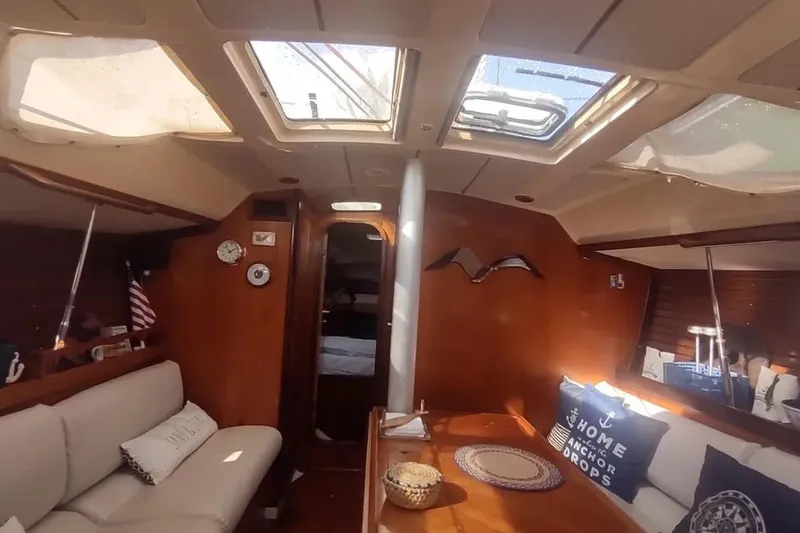 Slide: The Image of Interior of 1990 Beneteau Oceanis 390 sailboat with cozy seating and skylights. - 24