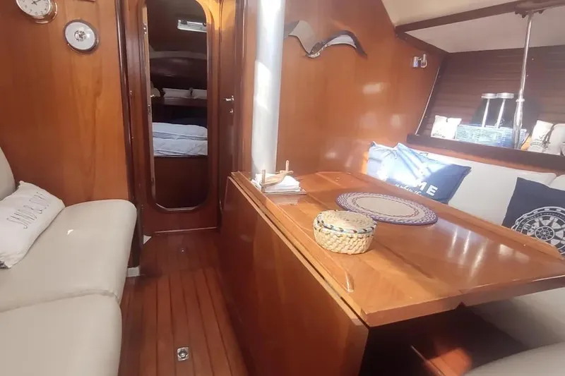 Slide: The Image of Cozy interior of 1990 Beneteau Oceanis 390 sailboat with wooden furnishings and nautical decor. - 29