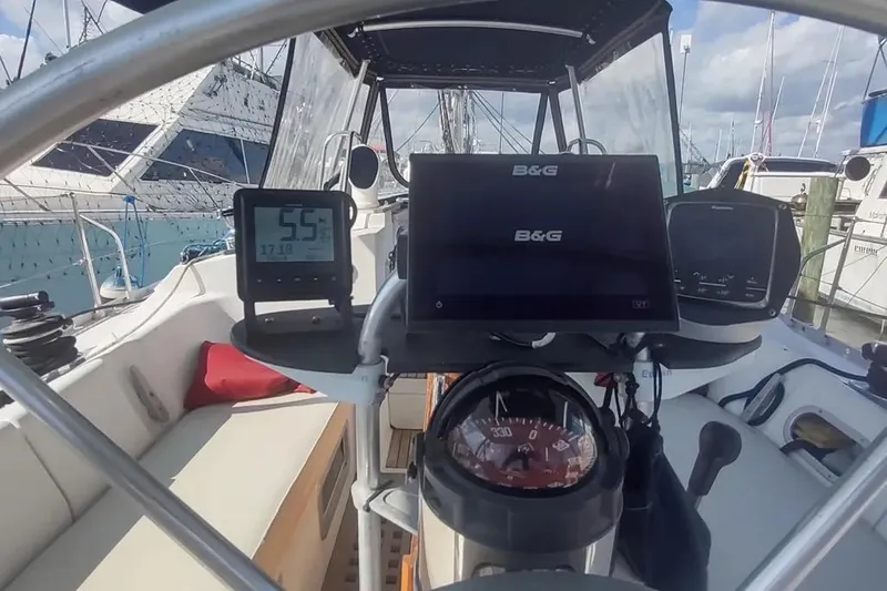 Slide: The Image of Cockpit of 1990 Beneteau Oceanis 390 sailboat with navigation instruments and steering wheel. - 3