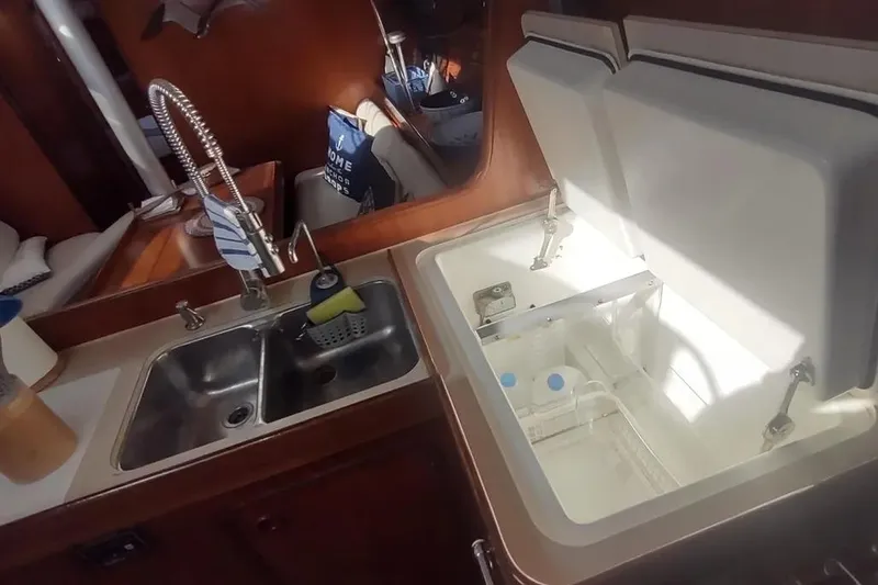 Slide: The Image of Interior of 1990 Beneteau Oceanis 390 yacht kitchen with sink and open storage. - 31