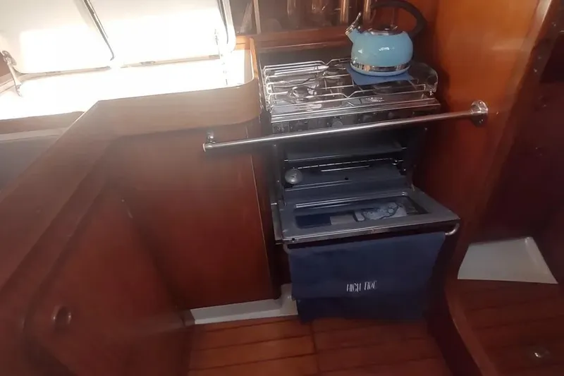 Slide: The Image of Galley kitchen in 1990 Beneteau Oceanis 390 sailboat with stove and kettle. - 32