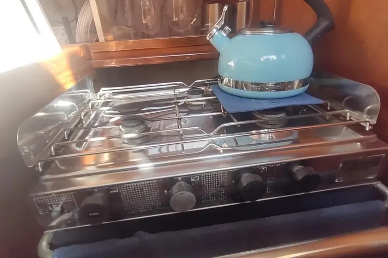 Slide: The Image of Stove with blue kettle in Beneteau Oceanis 390 yacht kitchen, 1990 model. - 33