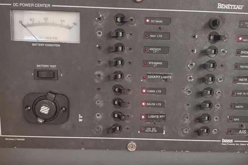 Slide: The Image of Control panel of a 1990 Beneteau Oceanis 390 sailboat, featuring various switches and battery indicators. - 36