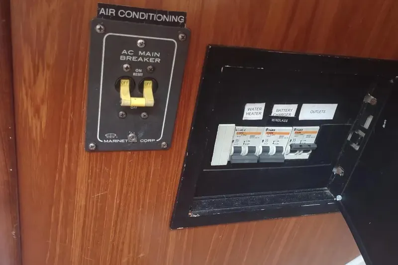 Slide: The Image of Electrical panel of a 1990 Beneteau Oceanis 390 sailboat, featuring AC main breaker. - 38