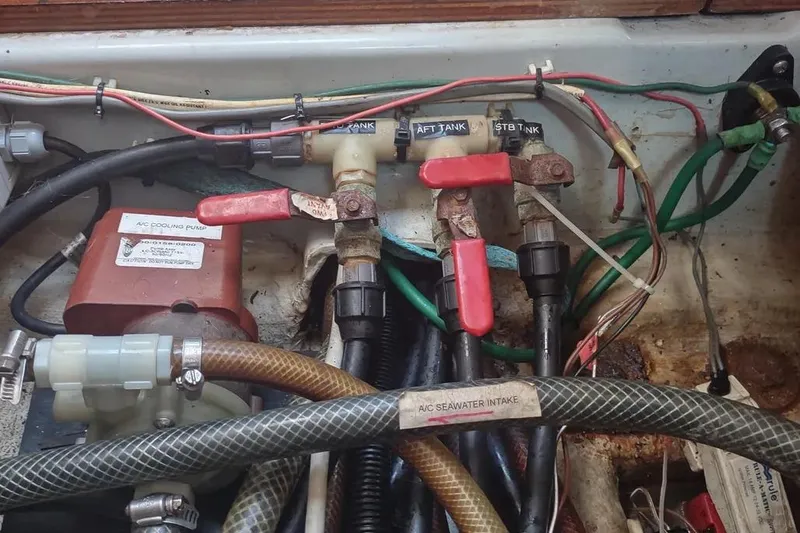 Slide: The Image of Engine compartment of a 1990 Beneteau Oceanis 390 sailboat showing valves and hoses. - 41