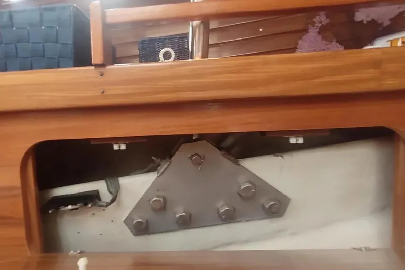 Slide: The Image of Interior view of 1990 Beneteau Oceanis 390 sailboat, showcasing wooden cabinetry and metal fittings. - 44