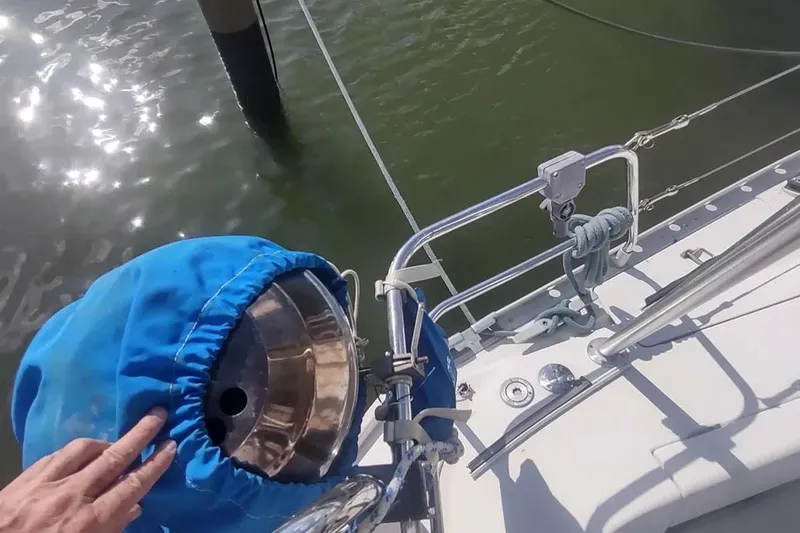 Slide: The Image of Sailboat deck view of 1990 Beneteau Oceanis 390 with blue-covered equipment. - 47