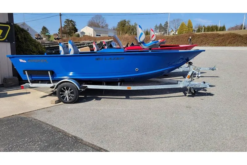The Image of 2026 Smoker Craft Lazer 161 boat in blue on a trailer, parked outdoors. - 0