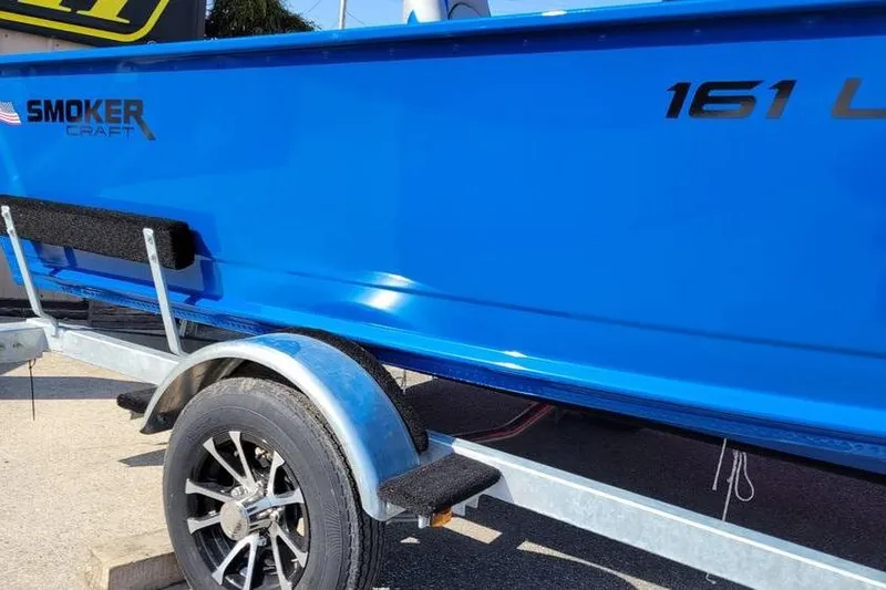 Slide: The Image of 2026 Smoker Craft Lazer 161 boat in vibrant blue on a trailer. - 11