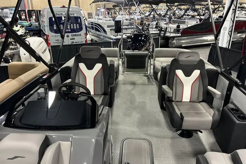 Slide: The Image of 2026 Evotti 721QL boat interior with modern seating and steering wheel at a boat show. - 4