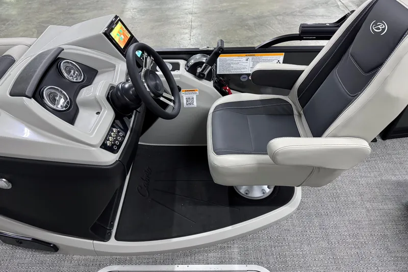 Slide: The Image of 2026 Barletta Cabrio 24UC boat cockpit with steering wheel and captain's chair. - 12