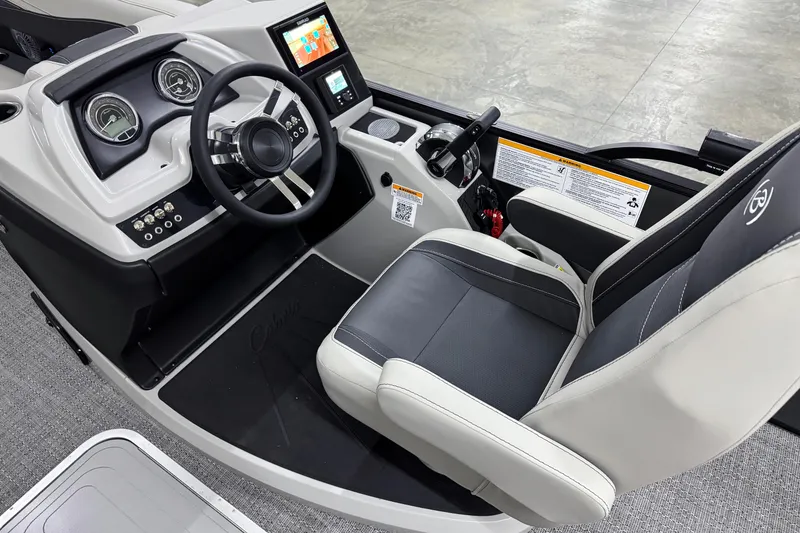 Slide: The Image of 2026 Barletta Cabrio 24UC boat interior with steering wheel and dashboard controls. - 13