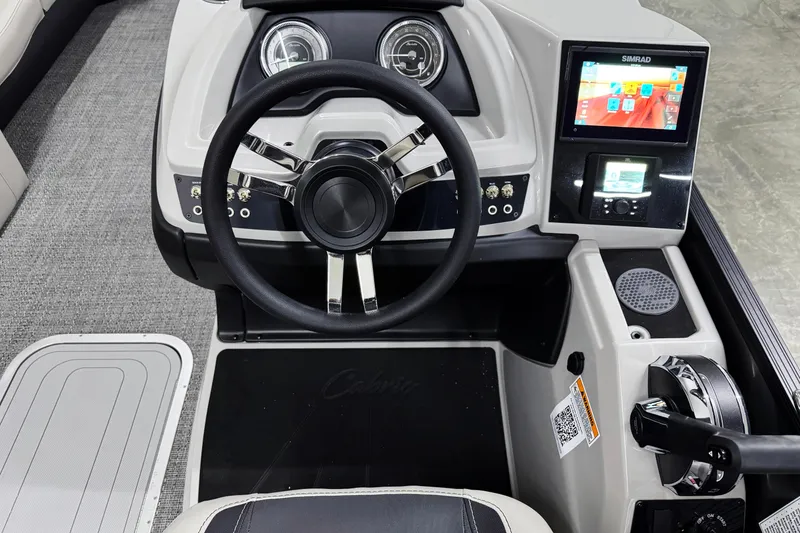 Slide: The Image of 2026 Barletta Cabrio 24UC boat dashboard with steering wheel and digital display. - 14