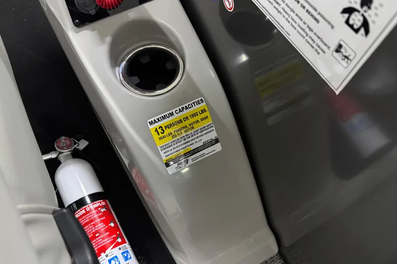 Slide: The Image of 2026 Barletta Cabrio 24UC boat interior with capacity label and fire extinguisher. - 15