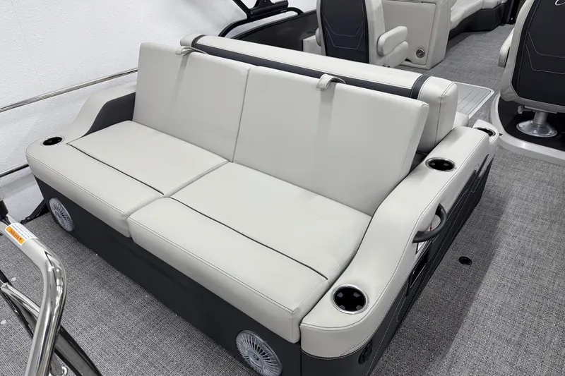 Slide: The Image of 2026 Barletta Cabrio 24UC boat interior with plush seating and cup holders. - 4