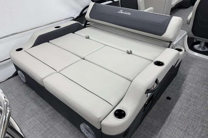 Slide: The Image of 2026 Barletta Cabrio 24UC boat interior with luxurious seating and cup holders. - 6