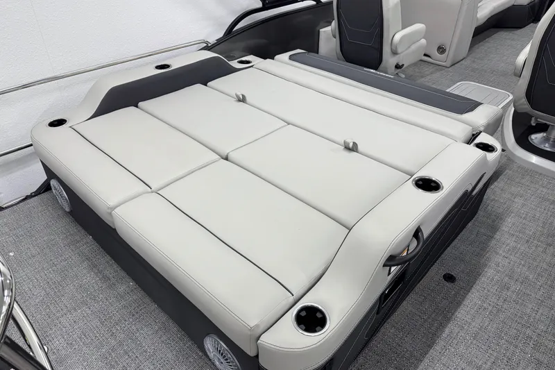 Slide: The Image of 2026 Barletta Cabrio 24UC boat interior with convertible seating and cup holders. - 7