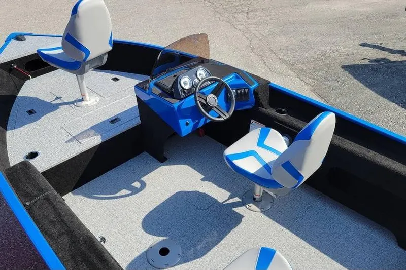 Slide: The Image of 2026 Smoker Craft Lazer 161 boat interior with blue and white seating and steering console. - 12