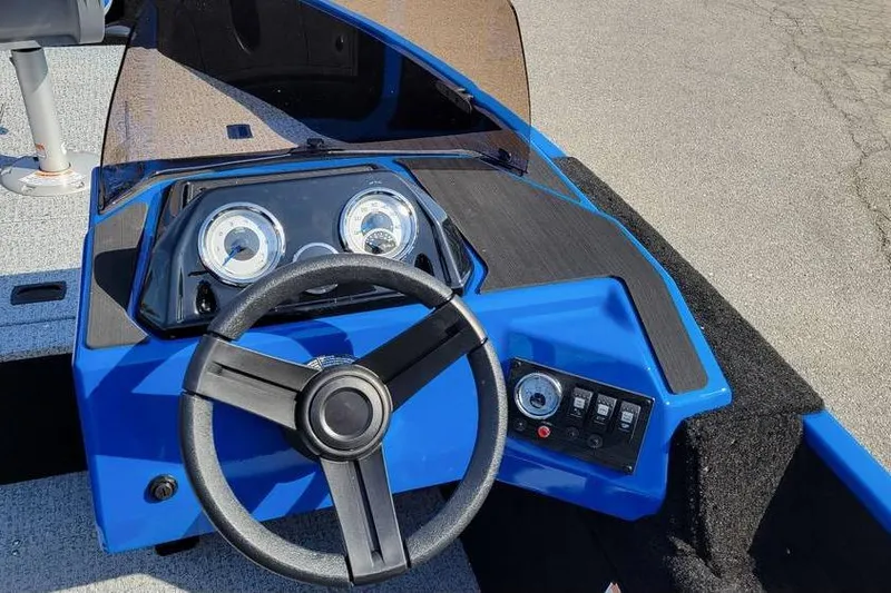 Slide: The Image of 2026 Smoker Craft Lazer 161 boat dashboard with steering wheel and instrument panel. - 15
