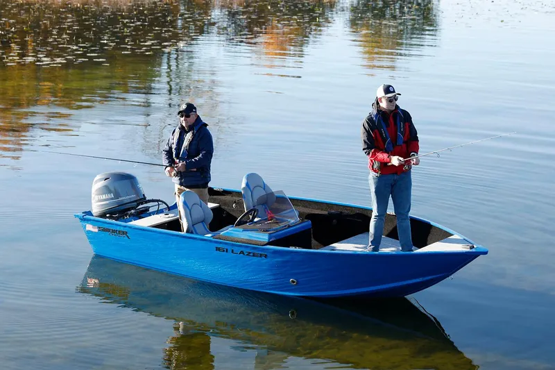 Slide: The Image of Manufacturer Provided Image: Two people fishing on a blue Smoker Craft Lazer 161 boat, 2026 model. - 2