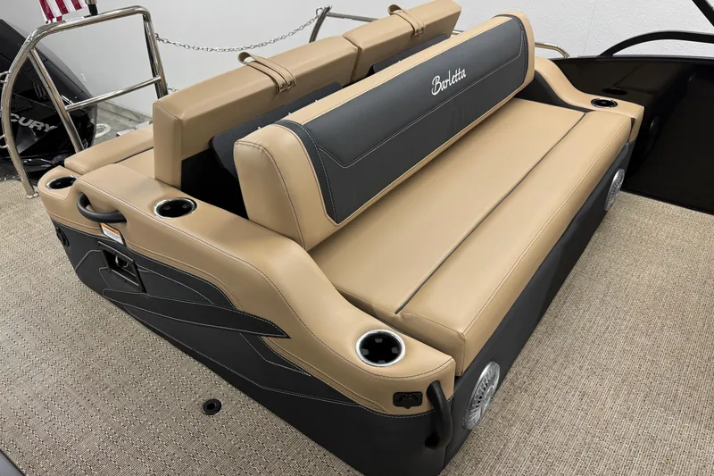 Slide: The Image of 2026 Barletta Cabrio 24UC boat seating with tan and black upholstery, cup holders, and speakers. - 10