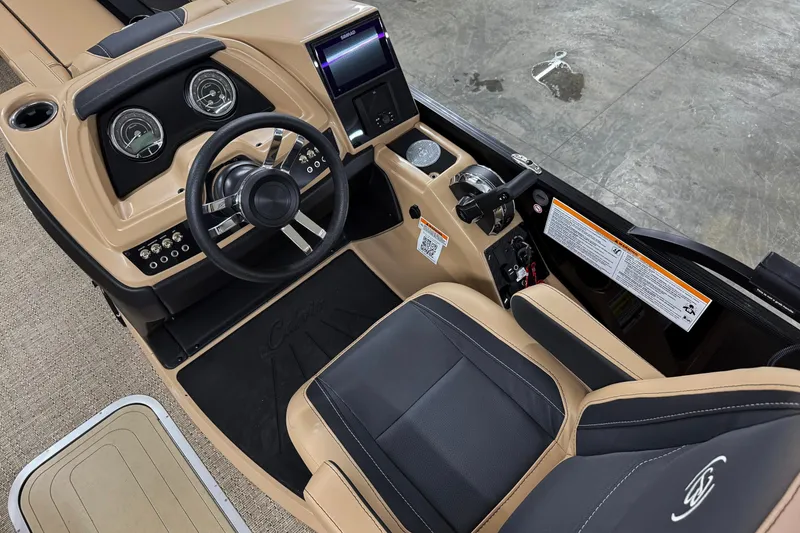 Slide: The Image of 2026 Barletta Cabrio 24UC boat interior with steering wheel and dashboard controls. - 13