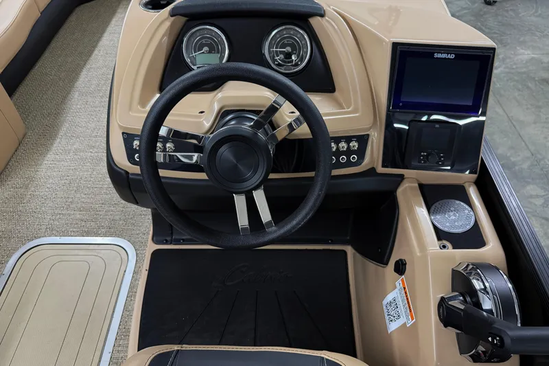 Slide: The Image of 2026 Barletta Cabrio 24UC boat dashboard with steering wheel and control panel. - 14
