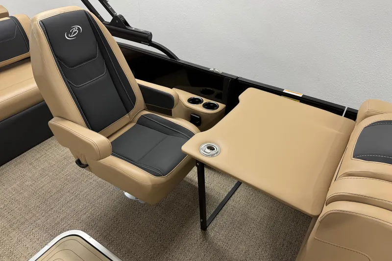 Slide: The Image of 2026 Barletta Cabrio 24UC interior with tan and black seating, table, and cup holders. - 18
