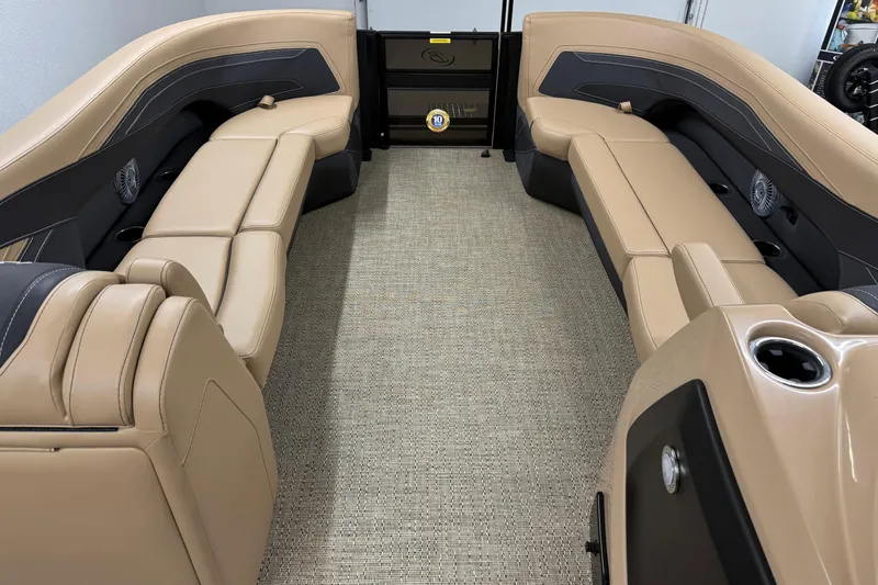 Slide: The Image of 2026 Barletta Cabrio 24UC boat interior with beige seating and cup holders. - 19