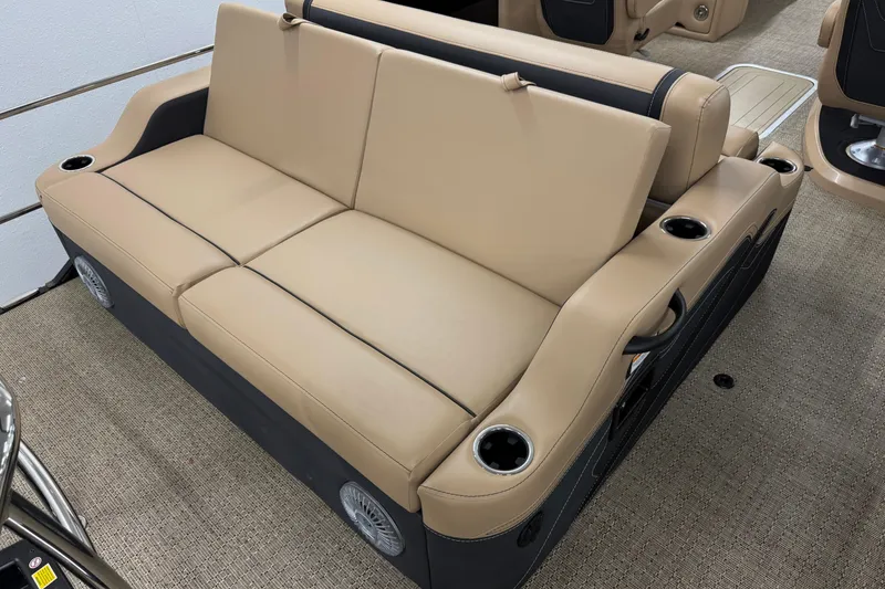Slide: The Image of 2026 Barletta Cabrio 24UC boat seating with beige upholstery and integrated cup holders. - 5