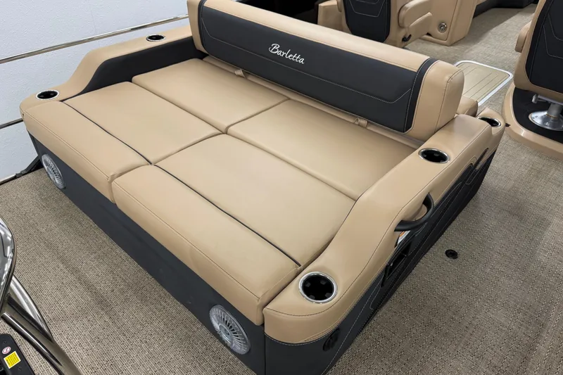 Slide: The Image of 2026 Barletta Cabrio 24UC boat interior with beige seating and cup holders. - 6