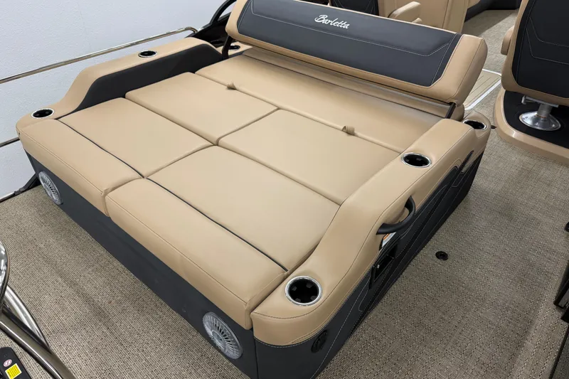 Slide: The Image of 2026 Barletta Cabrio 24UC boat interior with beige seating and cup holders. - 7