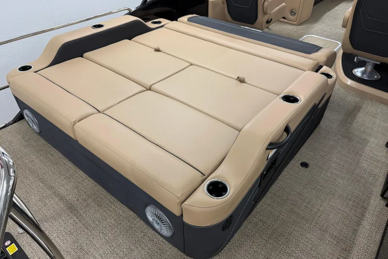 Slide: The Image of 2026 Barletta Cabrio 24UC boat interior with beige seating and cup holders. - 8