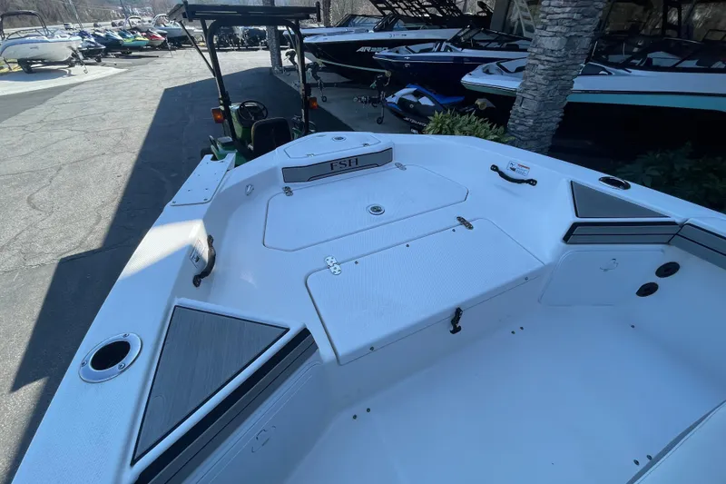 Slide: The Image of 2021 Yamaha Boats 195 FSH Sport, white interior, docked with other boats. - 15