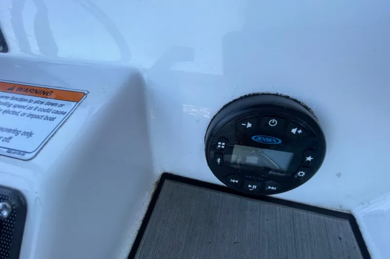 Slide: The Image of Control panel on 2021 Yamaha Boats 195 FSH Sport, featuring Jensen audio system. - 22