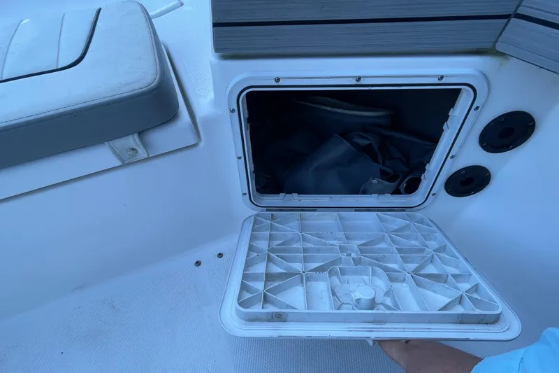 Slide: The Image of Open storage compartment on 2021 Yamaha Boats 195 FSH Sport, showing interior space. - 29